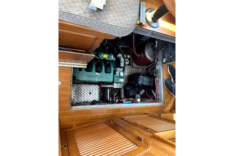 Slide: The Image of Engine compartment of a 1985 Baba 40 Pilot House sailboat, featuring a Volvo Penta engine. - 35