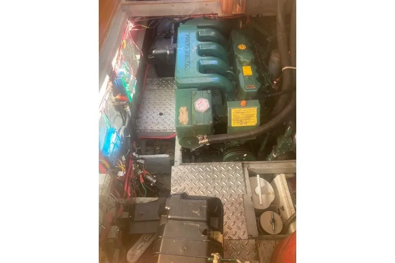 Slide: The Image of Engine compartment of a 1985 Baba 40 Pilot House sailboat, featuring a Volvo Penta engine. - 36