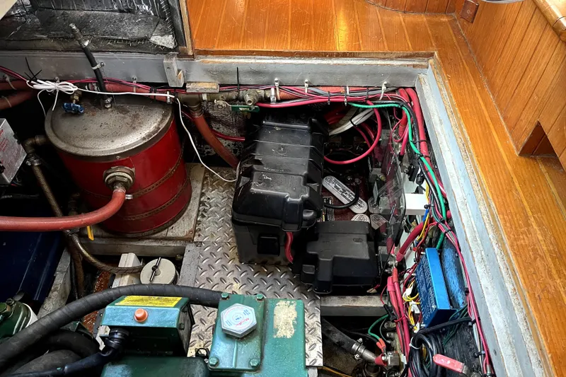 Slide: The Image of Engine room of a 1985 Baba 40 Pilot House sailboat, showcasing wiring and components. - 40
