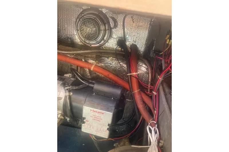 Slide: The Image of Engine compartment of a 1985 Baba 40 Pilot House with wiring and components. - 43