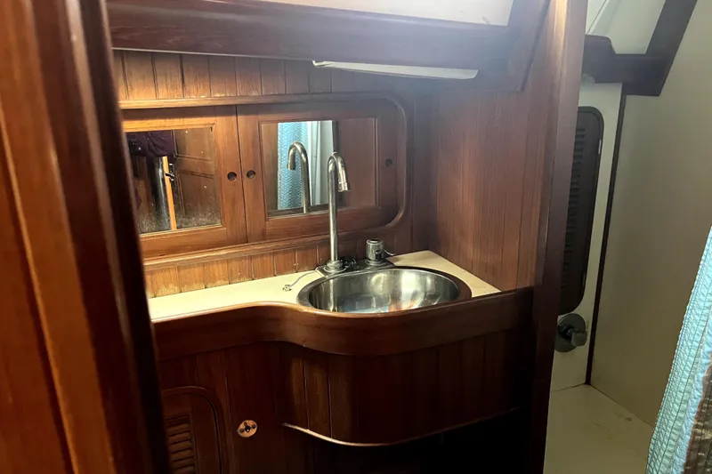 Slide: The Image of Wooden bathroom interior with sink in 1985 Baba 40 Pilot House yacht. - 55