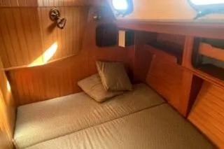 Slide: The Image of Interior of 1985 Baba 40 Pilot House with wooden table and cushioned seating. - 6