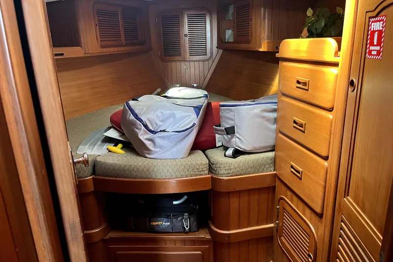 Slide: The Image of Cozy cabin interior of a 1985 Baba 40 Pilot House sailboat with wooden furnishings. - 62
