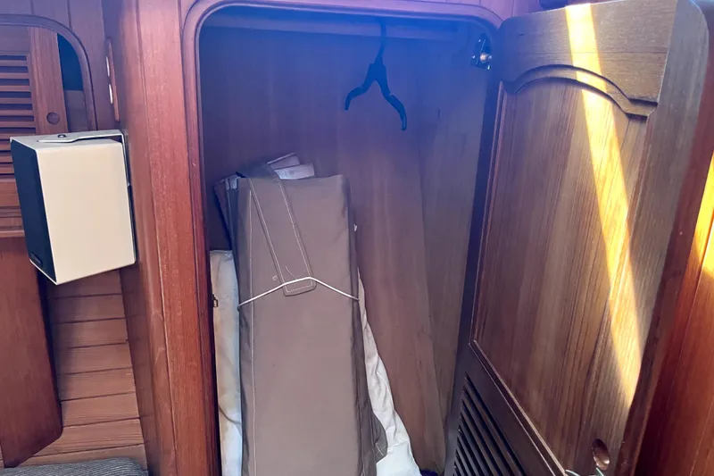 Slide: The Image of Wooden closet interior on a 1985 Baba 40 Pilot House boat. - 63