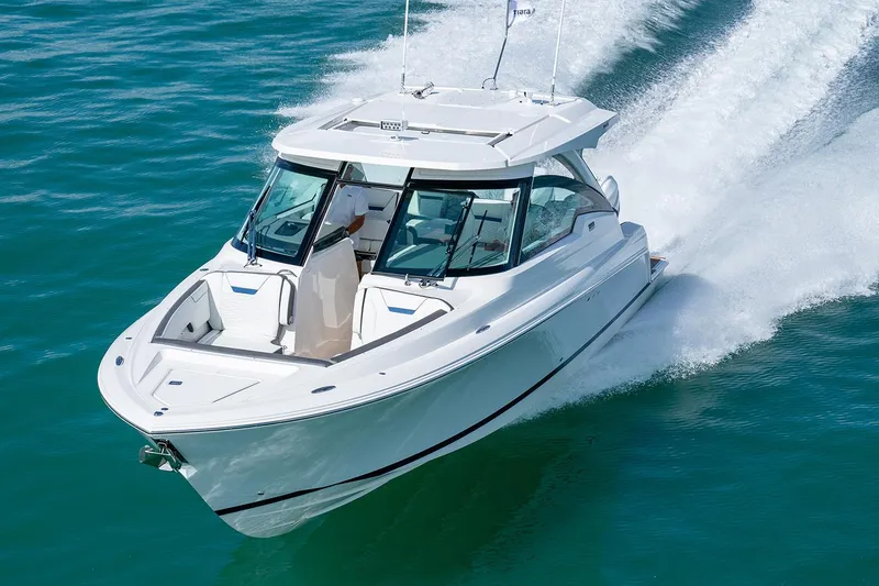 Slide: The Image of Manufacturer Provided Image: 2025 Tiara Yachts 34 LX cruising on clear blue water. - 2