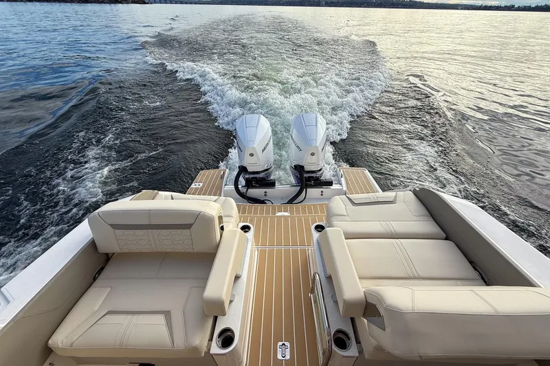 Slide: The Image of 2026 Tiara Yachts 34 LX cruising on water, showcasing luxurious seating and dual engines. - 22