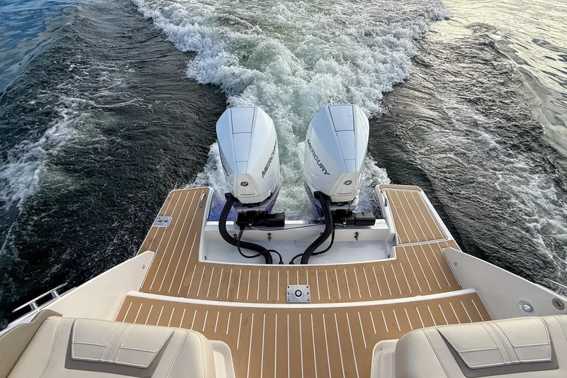Slide: The Image of 2026 Tiara Yachts 34 LX with dual Mercury outboard engines on water. - 23