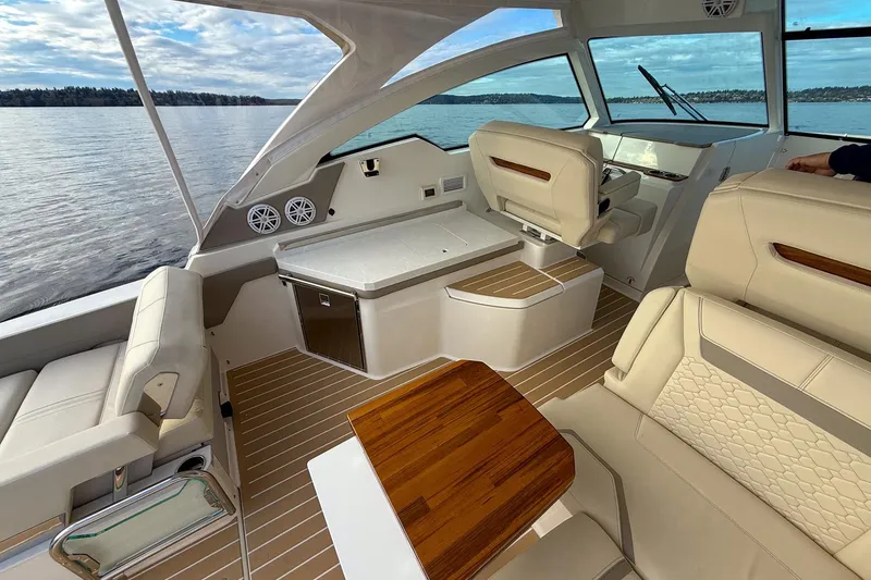 Slide: The Image of Luxurious interior of 2026 Tiara Yachts 34 LX, featuring elegant seating and wood accents. - 25