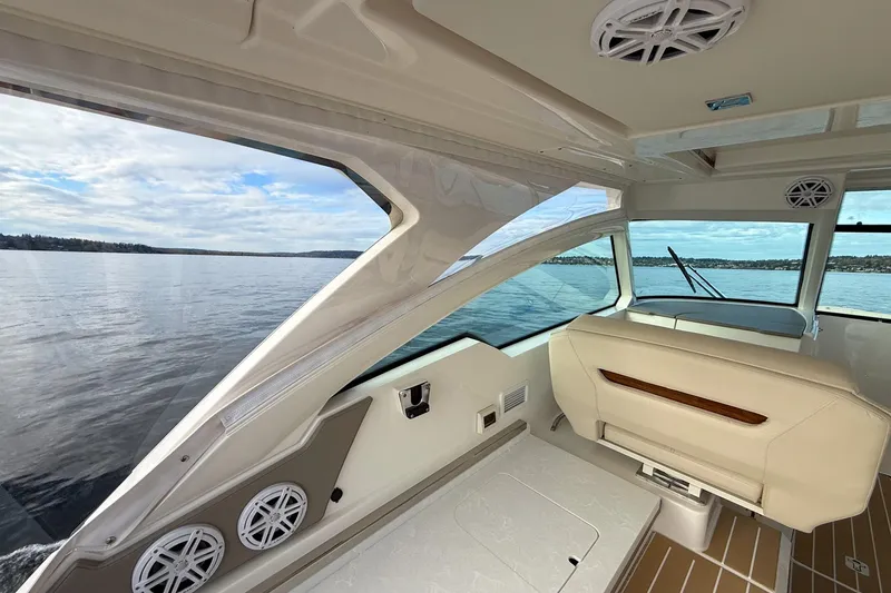 Slide: The Image of Interior view of 2026 Tiara Yachts 34 LX, showcasing seating and scenic water view. - 26