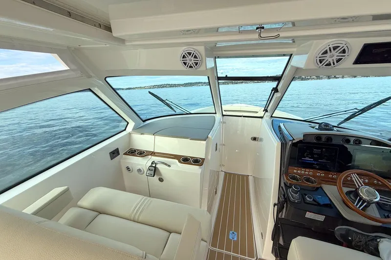 Slide: The Image of Interior view of 2026 Tiara Yachts 34 LX, featuring modern helm and seating. - 27