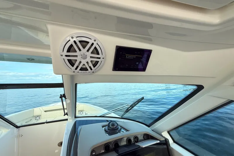 Slide: The Image of Interior view of 2026 Tiara Yachts 34 LX, featuring dashboard and speaker system. - 30