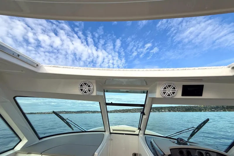 Slide: The Image of Interior view of 2026 Tiara Yachts 34 LX, showcasing panoramic windows and blue sky. - 31