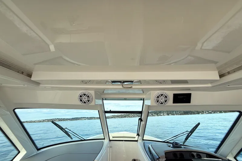 Slide: The Image of Interior view of 2026 Tiara Yachts 34 LX, showcasing helm and panoramic windows. - 32