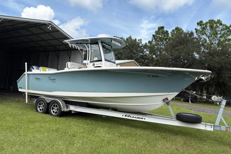The Image of 2021 Sea Hunt Gamefish 27 Coffin Box boat on trailer, parked near a shed. - 0