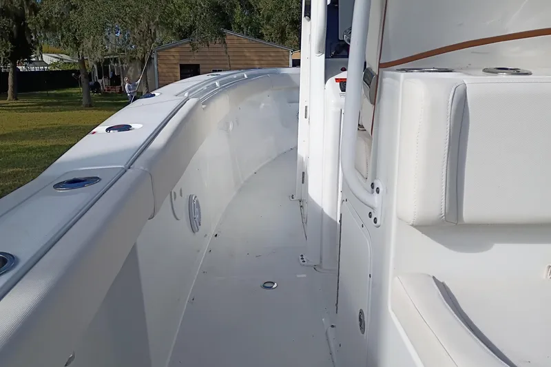 Slide: The Image of 2021 Sea Hunt Gamefish 27 Coffin Box boat interior, featuring sleek white seating and spacious deck. - 15