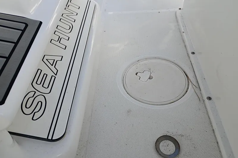 Slide: The Image of 2021 Sea Hunt Gamefish 27 Coffin Box deck detail with logo and hatch. - 17