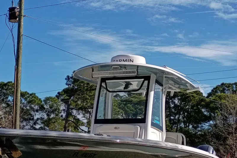 Slide: The Image of 2021 Sea Hunt Gamefish 27 Coffin Box boat with Garmin equipment under clear sky. - 19