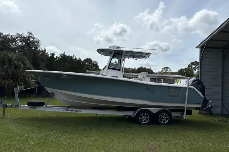 Slide: The Image of 2021 Sea Hunt Gamefish 27 Coffin Box boat on trailer, parked outdoors. - 2
