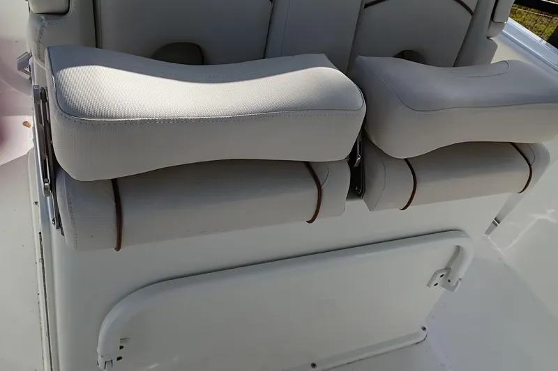 Slide: The Image of 2021 Sea Hunt Gamefish 27 Coffin Box boat seating, featuring cushioned armrests. - 21
