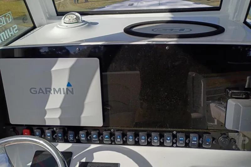 Slide: The Image of 2021 Sea Hunt Gamefish 27 dashboard with Garmin navigation system and control switches. - 23