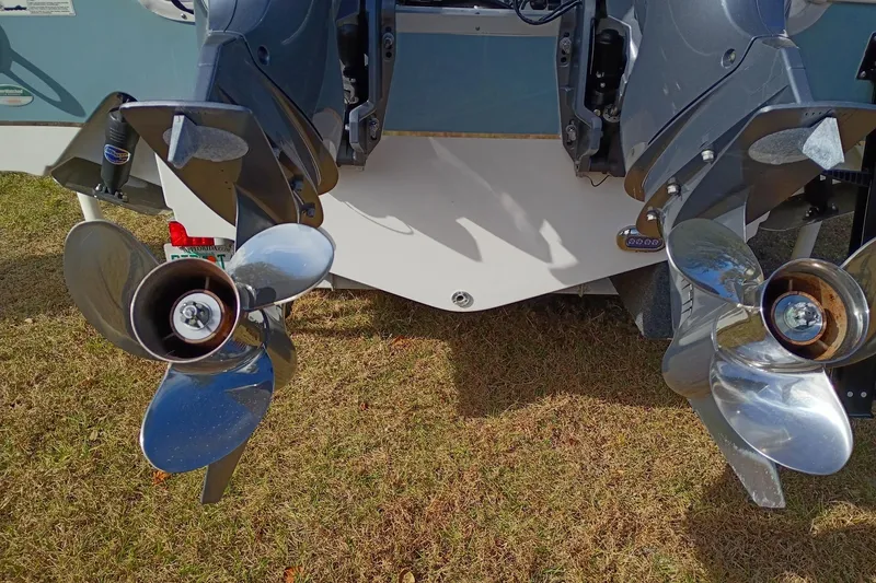 Slide: The Image of 2021 Sea Hunt Gamefish 27 Coffin Box boat propellers on grass. - 26