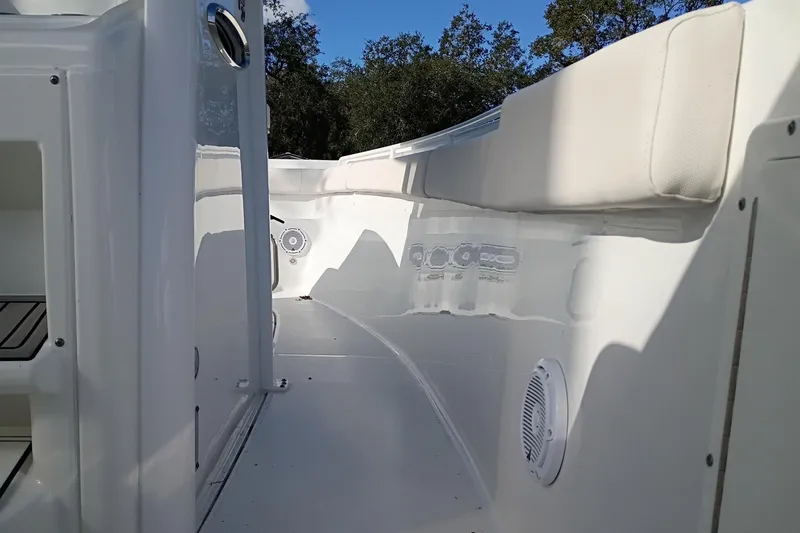 Slide: The Image of 2021 Sea Hunt Gamefish 27 Coffin Box interior with white seating and speakers. - 28
