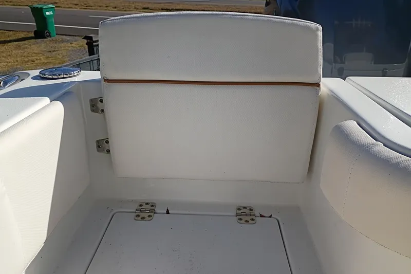 Slide: The Image of 2021 Sea Hunt Gamefish 27 Coffin Box boat interior with white cushioned seating. - 30
