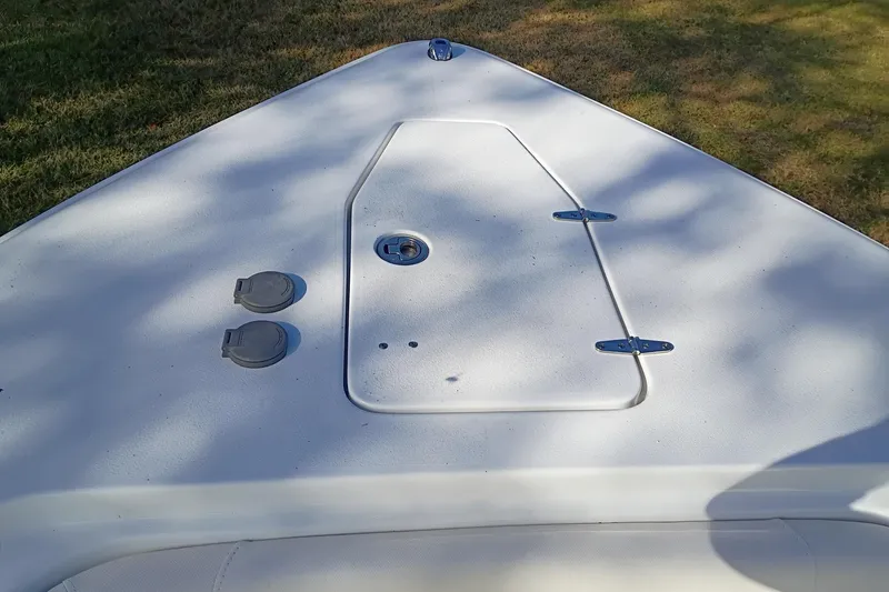 Slide: The Image of 2021 Sea Hunt Gamefish 27 Coffin Box deck, featuring storage hatch and fittings. - 34