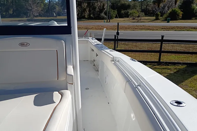 Slide: The Image of 2021 Sea Hunt Gamefish 27 Coffin Box boat interior with seating and railing. - 39