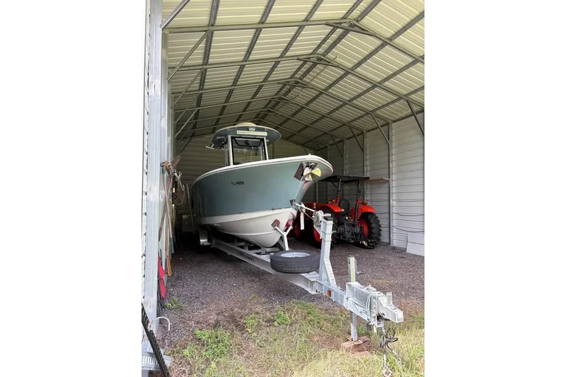 Slide: The Image of 2021 Sea Hunt Gamefish 27 Coffin Box boat in a metal storage shed. - 4
