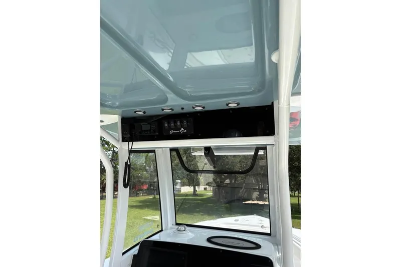 Slide: The Image of 2021 Sea Hunt Gamefish 27 Coffin Box boat interior with control panel and overhead view. - 5