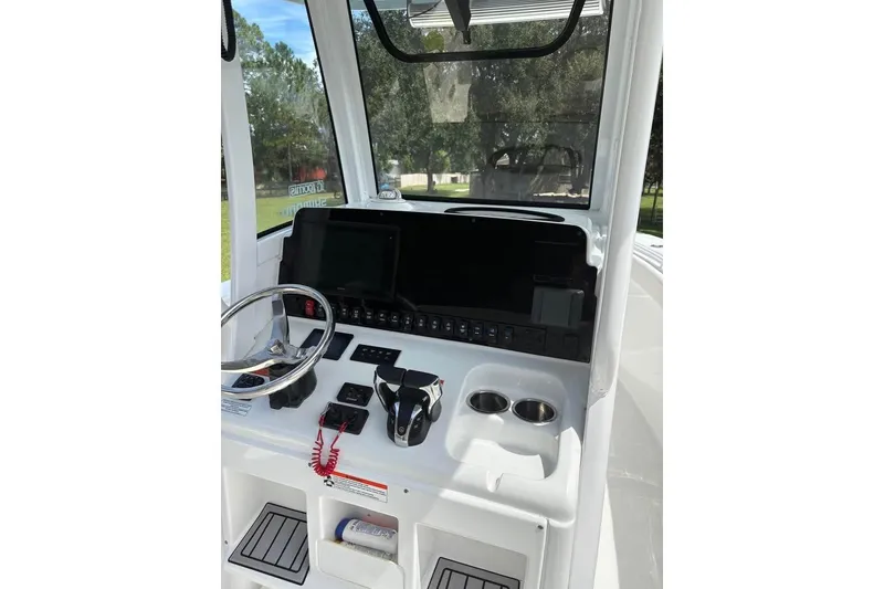 Slide: The Image of 2021 Sea Hunt Gamefish 27 Coffin Box boat console with steering wheel and controls. - 8