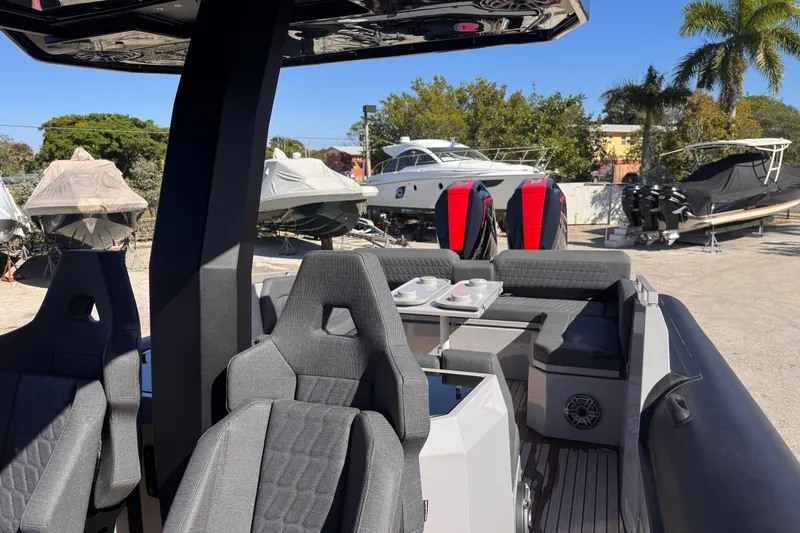 Slide: The Image of 2025 Skipper-BSK 38NC boat interior with modern seating and outdoor setting. - 12