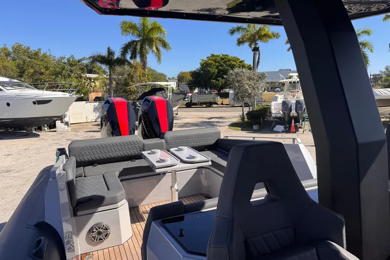 Slide: The Image of 2025 Skipper-BSK 38NC boat interior with seating, table, and dual engines. - 13