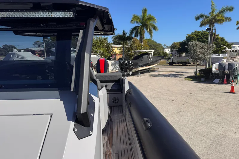Slide: The Image of 2025 Skipper-BSK 38NC boat docked, surrounded by palm trees and other vessels. - 19