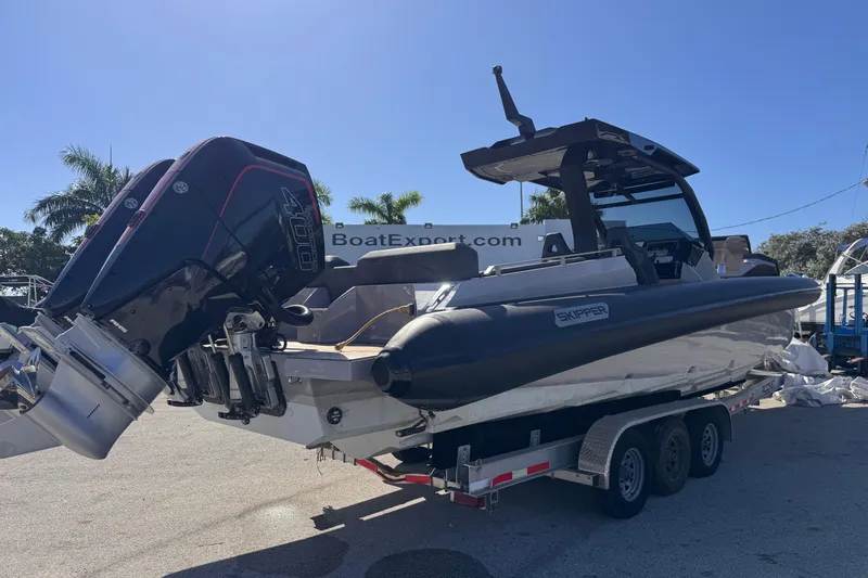 Slide: The Image of 2025 Skipper-BSK 38NC boat on trailer with powerful outboard engines. - 2