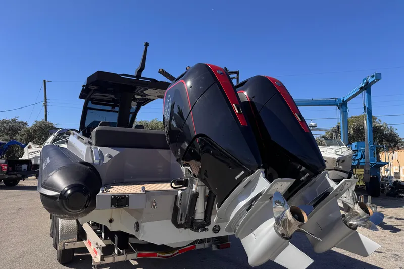 Slide: The Image of 2025 Skipper-BSK 38NC boat with dual outboard engines on a trailer. - 3