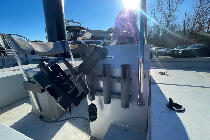 Slide: The Image of 2021 G3 Gator Tough 17 CCJ DLX boat interior with fishing rod holders and steering console. - 17