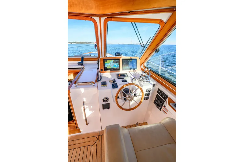 Slide: The Image of 2009 Sabre 42 Hard Top Express helm with navigation screens and wooden steering wheel. - 14