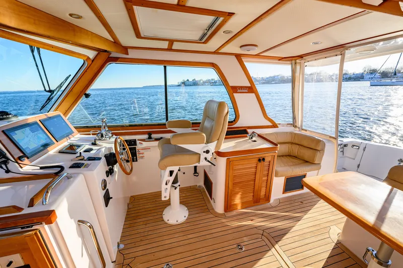 Slide: The Image of Interior of 2009 Sabre 42 Hard Top Express yacht with helm, seating, and ocean view. - 15