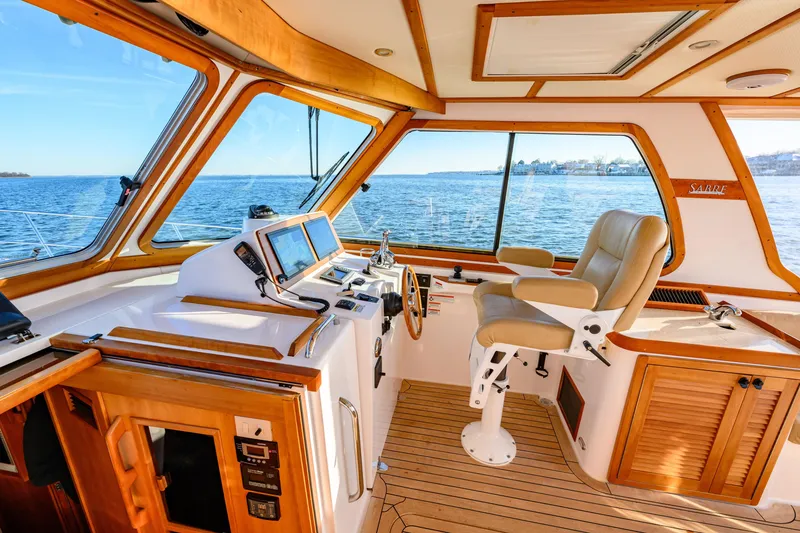 Slide: The Image of 2009 Sabre 42 Hard Top Express yacht interior with helm, navigation screens, and ocean view. - 16