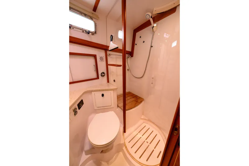 Slide: The Image of 2009 Sabre 42 Hard Top Express yacht bathroom with shower, toilet, and wooden accents. - 26