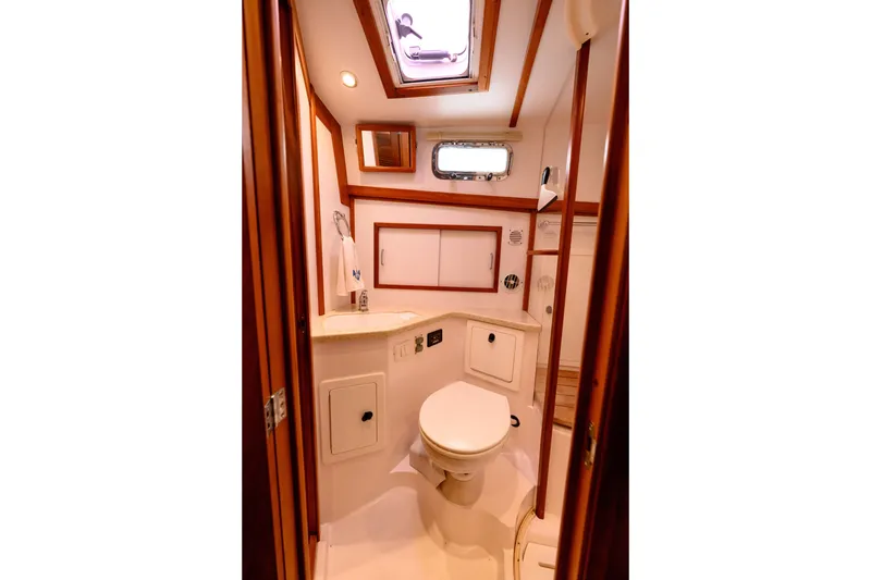 Slide: The Image of 2009 Sabre 42 Hard Top Express yacht bathroom with wooden accents and modern fixtures. - 27