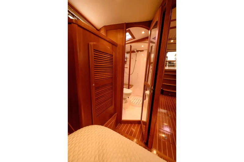 Slide: The Image of Interior of 2009 Sabre 42 Hard Top Express yacht, featuring wooden cabinetry and bathroom. - 28