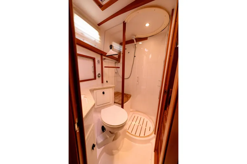 Slide: The Image of 2009 Sabre 42 Hard Top Express yacht bathroom with shower, toilet, and wooden accents. - 29