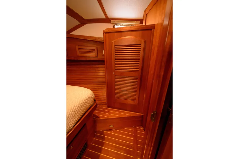Slide: The Image of Interior of 2009 Sabre 42 Hard Top Express yacht with wooden cabinetry and cozy bed. - 30
