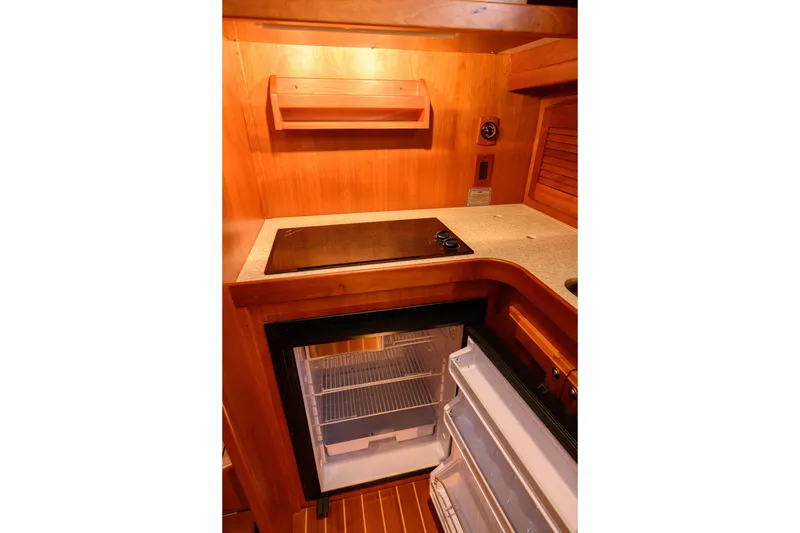 Slide: The Image of 2009 Sabre 42 Hard Top Express galley with stove and open refrigerator. - 35