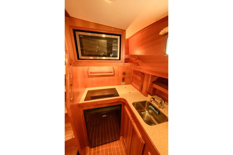 Slide: The Image of 2009 Sabre 42 Hard Top Express yacht kitchen with microwave, stove, and sink. - 37