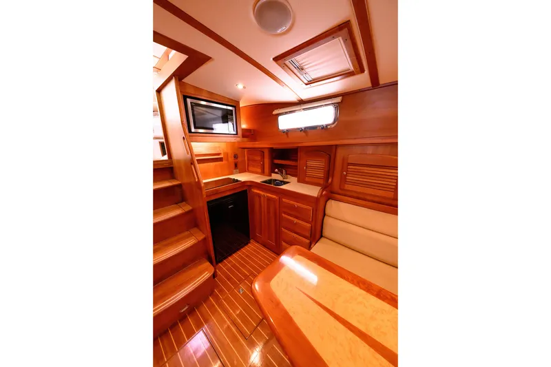 Slide: The Image of 2009 Sabre 42 Hard Top Express interior with wooden cabinetry, seating, and kitchenette. - 38