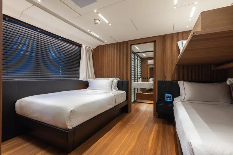 Slide: The Image of Luxurious bedroom interior on 2020 Sanlorenzo 44 Alloy yacht, featuring elegant wood finishes. - 34